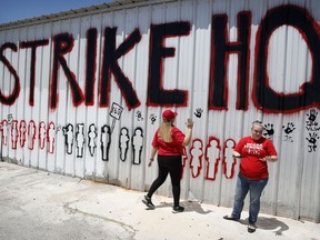 Members of the the Culinary Union paint a wall at a union hall Friday, June 1, 2018, in Las Vegas. Caesars Entertainment and the union have reached a tentative labor agreement on Friday that would cover about a quarter of the 50,000 casino-hotel workers that are threatening to strike in Las Vegas.