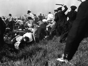 FILE - In this May 30, 1937 file photo, police using guns, clubs and tear gas advance into marching strikers outside Chicago's Republic Steel plant during violent clashes in the early days of labor union organizations.