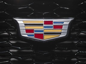 FILE - This March 27, 2018, file photo shows a Cadillac emblem on the front of a grill on a vehicle at the New York Auto Show. General Motors says it will get rid of three Cadillac sedans and replace them with two during the next 3½ years.