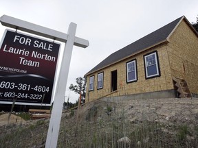 In this Wednesday, June 20, 2018, photo, a for sale sign is displayed in front of home under construction in Raymond, N.H. On Monday, June 25, the Commerce Department reports on sales of new homes in May.