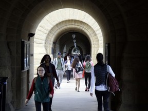 FILE- In this Jan. 13, 2016, file photo, students walk on campus at Stanford University in Stanford, Calif. To make postgrad life easier and more affordable, work on your credit this summer.