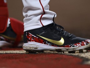 FILE- In this May 4, 2018, file photo, shows a view of the Nike Flywire cleats worn by Cincinnati Reds' Eugenio Suarez in the seventh inning of a baseball game against the the Miami Marlins in Cincinnati. Nike reports financial results on Thursday, June 28.
