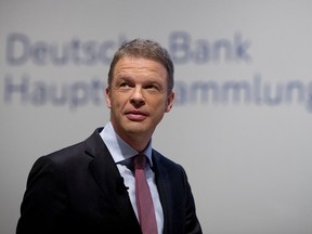 FILE- In this May 24, 2018, file photo, CEO of Deutsche Bank Christian Sewing makes his way to the annual meeting of the bank in Frankfurt, Germany. Shares of Deutsche Bank have tumbled more 7 percent on a report that Federal Reserve downgraded the German bank's U.S. business to "troubled condition" about a year ago. The designation is one of the lowest that the Fed assigns and had not been made public before The Wall Street Journal reported it on Thursday, May 31.