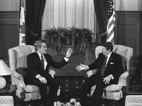 FILE- In this March 17, 1985, file photo, Canadian Prime Minister Brian Mulroney and U.S. President Ronald Reagan hold their first round of talks in Quebec City, Quebec. When Reagan visited Canada, he was so friendly with then Prime Minister Brian Mulroney they sang a song together. When President Donald Trump visits this week there's speculation he could walk out of meetings with allies furious over his belligerent trade policies.