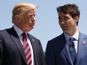 FILE- In this June 8, 2018, file photo, President Donald Trump talks with Canadian Prime Minister Justin Trudeau during a G-7 Summit welcome ceremony in Charlevoix, Canada. Canada announced Friday, June 29, billions of dollars in retaliatory tariffs against the U.S. in response to the Trump administration's duties on Canadian steel and aluminum, saying Friday it won't back down.