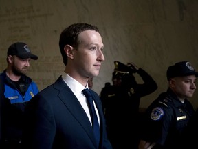 FILE - In this April 11, 2018, file photo, Facebook CEO Mark Zuckerberg departs after testifying before a House Energy and Commerce hearing on Capitol Hill in Washington about the use of Facebook data to target American voters in the 2016 election and data privacy. The New York Times says Facebook has acknowledged it shared user data with several Chinese handset manufacturers, including Huawei, a company flagged by U.S. intelligence officials as a national security threat. The report says Facebook said Tuesday, June 5, the handset makers including Huawei, Lenovo, Oppo and TCL were among 60 it had shared data with as early as 2007. Facebook told the newspaper it planned to wind down the Huawei deal this week.