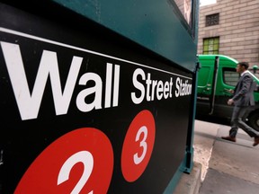 FILE- In this April 5, 2018, file photo, a sign for a Wall Street subway station is shown in New York. The U.S. stock market opens at 9:30 a.m. EDT on Monday, June 25.