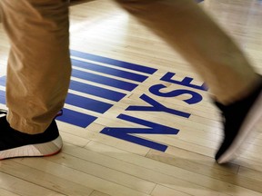 FILE- In this April 5, 2018, file photo, an NYSE logo adorns the entrance to the trading floor the New York Stock Exchange. The U.S. stock market opens at 9:30 a.m. EDT on Thursday, June 21.