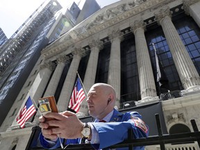 FILE- In this April 26, 2018, file photo, Vincent Pepe stands outside the New York Stock Exchange where he works in the Financial District in New York. The U.S. stock market opens at 9:30 a.m. EDT on Friday, June 15.