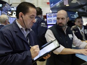 Trader Tommy Kalikas, left, and specialist James Denaro work on the floor of the New York Stock Exchange, Friday, June 8, 2018. Stock indexes are opening modestly lower on Wall Street as technology companies and retailers fall.