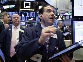 Trader Tommy Kalikas, right, works on the floor of the New York Stock Exchange, Monday, June 11, 2018. Stocks are opening higher on some corporate deal news.