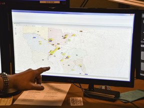 FILE - In this March 15, 2018, file photo, a supervisor shows one of the maps used by dispatchers at a 911 call center in Roswell, Ga. Apple is trying drag the U.S.'s antiquated system for handling 911 calls into the 21st century. If it lives up to Apple's promise, the iPhone's next operating system will automatically deliver quicker and more reliable information pinpointing the location of 911 calls to about 6,300 emergency response centers in the U.S.