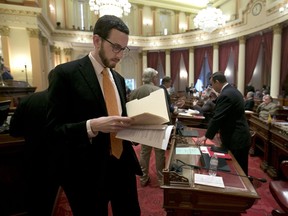 FILE - In this April 20, 2017 file photo, State Sen. Scott Wiener, D-San Francisco works at the Capitol in Sacramento, Calif. Sen. Scott Wiener has been pushing legislation to revive regulations repealed last year by the Federal Communications Commission that prevented internet companies from exercising more control over what people watch and see over the internet.