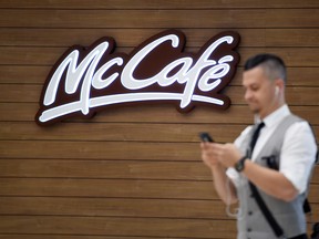 A man walks past the McDonald's McCafe sign on Bloor Street West.