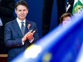 Italian Premier Giuseppe Conte, left, flanked by Senate president Maria Elisabetta Alberti Casellati, attends the celebrations for Italy's Republic Day, in Rome Saturday, June 2, 2018. At an oath-taking ceremony in the presidential palace atop Quirinal Hill, the new premier, political novice Giuseppe Conte, and his 18 Cabinet ministers pledged their loyalty to the Italian republic and to the nation's post-war constitution in front of President Sergio Mattarella.
