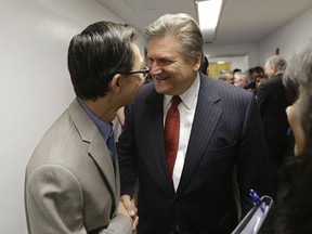 Assemblyman Ed Chau, D-Arcadia, left, and Sen. Bob Hertzberg, D-Van Nuys, celebrate after their internet privacy bill was approved by the Senate Judiciary Committee, Tuesday, June 26, 2018, in Sacramento, Calif. The bill would let consumers ask companies to delete their information or refrain from selling it, among other data privacy provisions. The bill, which is aimed to keep a related initiative off the November ballot.