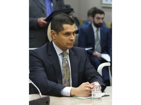 FILE -- In this June 14, 2016 file photo Assemblyman Miguel Santiago, D-Los Angeles, appears before the Senate Public Safety Committee, in Sacramento, Calif. Santiago says, Friday, June 22, 2018, that his family is being harassed online because he altered a bill aimed at restoring net neutrality.