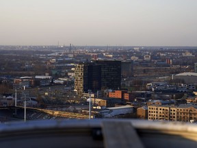 In this Monday, April 9 2018 photo, the sun sets over the offices of the now-defunct Latvian bank, ABLV, in Riga.  Latvia has come into focus as a potential weak link in the West's banking system as the U.S. and EU increasingly rely on financial sanctions as a weapon in their diplomatic spats with North Korea, but also Russia and Syria, among others.