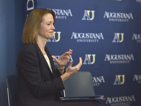 In this April 6, 2018 photo Augustana University President Stephanie Herseth Sandlin  introduces Josh Morton as the new Director of Athletics at a news conference  at Augustana University in Sioux Falls, S.D. Many supporters of Augustana University hope to see the school move from Division II to Division I athletics. Three other schools in the Dakotas have been successful in moving up to Division I in recent years.