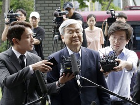 Cho Yang-ho, center, the chairman of Korean Air Lines Co., arrives for an investigation over allegations of embezzlement at the Seoul Southern District Prosecutors' Office in Seoul, South Korea, Thursday, June 28, 2018. His appearance makes him the latest founding family member of the South Korean flag carrier to face authorities' investigation since April.