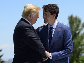 Prime Minister Justin Trudeau greets U.S. President Donald Trump during the official welcoming ceremony at the G7 Leaders Summit in La Malbaie, Que., on Friday, June 8, 2018.