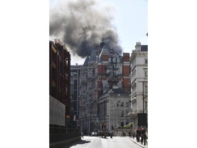 Smoke rises from a building in Knightsbridge, central London, as London Fire Brigade responded to a call of a fire in this upmarket location, Wednesday June 6, 2018.