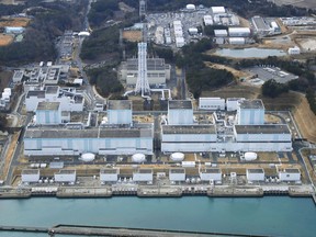 In this February 2018, aerial photo shows Fukushima Dai-ni, or No. 2, nuclear power plant in Naraha, Fukushima Prefecture, northeastern Japan. Tokyo Electric Power Company Holdings said Thursday, June 14, 2018, it was considering dismantling four reactors at the plant, which has never restarted since the 2011 disaster. If Fukushima No. 2 were to be scrapped, the number of workable reactors in Japan would fall to 35, down from 54 before the disaster. (Kyodo News via AP)