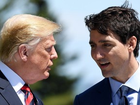 Prime Minister of Canada Justin Trudeau, right, speaks with U.S. President Donald Trump during the G7 Summit in Quebec City.