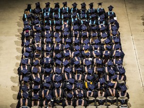 FILE- In this Sept. 30, 2017, file photo, people attend the WGU Texas annual commencement ceremony at the Frank Erwin Center in Austin, Texas. The public service loan forgiveness program was created to encourage people to take jobs to help the greater good without financially crippling themselves. These positions often require higher education but pay modest wages, such as teaching, social work, public health or law enforcement.