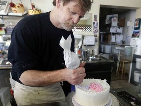 FILE - In this March 10, 2014, file photo, Masterpiece Cakeshop owner Jack Phillips decorates a cake inside his store in Lakewood, Colo. The Supreme Court is setting aside a Colorado court ruling against a baker who wouldn't make a wedding cake for a same-sex couple. But the court is not deciding the big issue in the case, whether a business can refuse to serve gay and lesbian people.