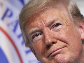 In this June 1, 2018 photo, President Donald Trump attends a Change of Command ceremony at the U.S. Coast Guard Headquarters in Washington. Trump is defending his tough trade negotiations with China, Canada and Mexico, saying that U.S. farmers have been treated "unfairly." The president says on Twitter that by the time he finishes his trade negotiations, "that will change" and big trade barriers "will finally be broken."