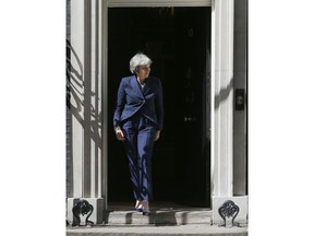 Britain's Prime Minister Theresa May walks out of 10 Downing Street to greet Prime Minister Ema Solberg of Norway in London, Wednesday, June 6, 2018. May and Solberg held talks inside 10 Downing Street.