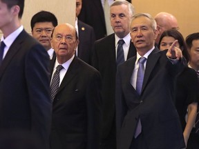 U.S. Commerce Secretary Wilbur Ross, second from left, and Chinese Vice Premier Liu He, right, arrive to attend a meeting at the Diaoyutai State Guesthouse in Beijing, Sunday, June 3, 2018. U.S. Commerce Secretary Ross is in Beijing for talks on China's promise to buy more American goods after Washington ratcheted up tensions with a new threat of tariff hikes on Chinese high-tech exports.