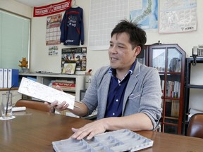 In this May 11, 2018 photo, Sakae Casting Co. President Takashi Suzuki shows samples of his company's casting products in his office in Hachioji, in the outskirts of Tokyo. President Donald Trump's trade relations with Tokyo are testy, but Idaho gave Suzuki a warm welcome. Suzuki, whose company  manufactures aluminum parts used for cooling batteries and semiconductors, first went to Silicon Valley looking for opportunities. But that was where everyone went, making for tough competition.
