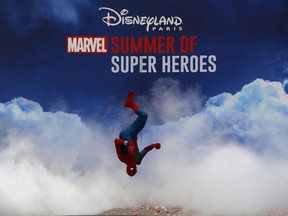 Spiderman character performs during the opening show at Disneyland Paris, west of Paris, Saturday, June 8, 2018. Helicopters, concept cars and swat teams shrouded in smoke heralded the launch of the first Avengers-themed season at Disneyland Paris following the announcement of a $2.5 billion expansion plan for the park, which will feature Marvel superheroes.