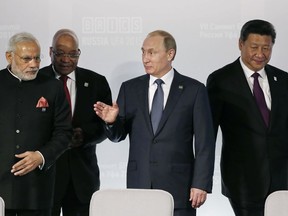 FILE - In this July 9, 2015, file photo, from left: Indian Prime Minister Narendra Modi, South African President Jacob Zuma, President of Russia Vladimir Putin and President of China Xi Jinping attend a signing ceremony at the BRICS Summit which is held together with SCO (Shanghai Cooperation Organisation) in Ufa, Russia. The SCO (Shanghai Cooperation Organisation), a Beijing-based group was originally conceived as a platform for resolving border issues, fighting terrorism and - more implicitly - to counter American influence. In recent years, its economic component has grown more prominent with China's trillion-dollar infrastructure drive known as the Belt and Road Initiative.