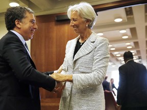 FILE - In this May 10, 2018 file photo, International Monetary Fund (IMF) Managing Director Christine Lagarde, right, meets with Argentina's Treasury Minister Nicolas Dujovne, at the IMF in Washington. Argentina and the IMF have agreed on a $50 billion stand-by deal aimed at strengthening the South American country's economy, announced on Thursday, June 7, 2018.