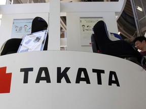 FILE - In this May 4, 2016 file photo, visitors look at child seats, manufactured and displayed by Takata Corp. at an automaker's showroom in Tokyo. Japanese carmaker Honda said Friday, June 1, 2018, another person has died in Malaysia after a flawed Takata airbag inflator exploded, raising the number of deaths linked to the defect in the Southeast Asian country to seven.