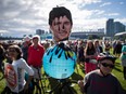 A protester holds a photo of Prime Minister Justin Trudeau and a representation of the globe covered in oil during a Vancouver protest against the Kinder Morgan Trans Mountain Pipeline expansion.