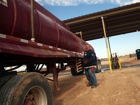 An oilfield worker fills his truck before heading to a drilling site in the Permian Basin oil field.