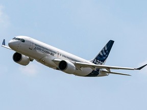 An Airbus A220 lands at Toulouse-Blagnac airport, southwestern France on July 10, 2018. Airbus says JetBlue has signed a deal to buy 60 A220-300 aircraft.