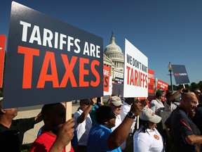 Auto workers rally against U.S. President Donald Trump's proposed tariffs on auto imports and the impact on auto makers and their surrounding communities, during a news conference on Capitol Hill, on July 19, 2018 in Washington, D.C.