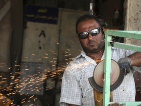 In this Wednesday, July 25, photo, Najm Abdul Jabbar, 40, who holds a bachelor's degree and works in a blacksmith shop is shown in Baghdad, Iraq. Mismanagement since the 2003 U.S.-led invasion that toppled Saddam Hussein has increased joblessness nationwide, posing threat to stability in southern Iraq.