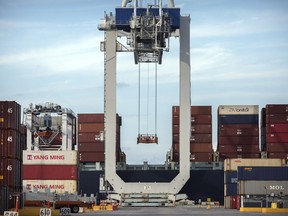 FILE - In this Thursday, July 5, 2018, photo, a ship to shore crane prepares to load a 40-foot shipping container onto a container ship at the Port of Savannah in Savannah, Ga. China's options to retaliate in an escalating trade dispute with Washington go beyond matching U.S. tariff hikes to targeting American companies and government debt. Its state-dominated economy gives regulators tools to hamper sales of engineering, shipping and other services _ an area in which the United States runs a trade surplus _ and to disrupt operations for automakers, restaurant chains and other American businesses in China.