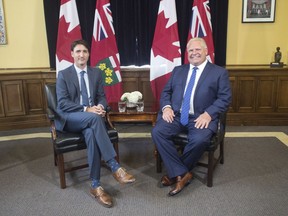 Ontario Premier Doug Ford (right) sits with Canadian Prime Minister Justin Trudeau at the Ontario Legislature, in Toronto on Thursday, July 5, 2018.