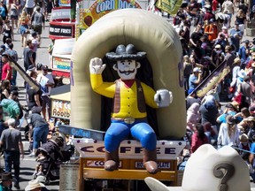 Crowds walk along the midway during the Calgary Stampede in Calgary on July 8, 2018. The local economy is looking good as Calgary Stampede spirit envelops Canada's oil and gas headquarters city -- but not quite as good as it was a few years ago. The annual outdoor event started off by setting an attendance record on parade day last Friday but since then has settled back, with cumulative attendance through Tuesday coming in second to the overall record year of 2012, when the Stampede celebrated its 100th year.