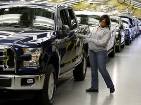 In this Friday, March 13, 2015, file photo, a worker inspects a new aluminum-alloy body Ford F-150 truck at the company's Kansas City Assembly Plant, in Claycomo, Mo. Ky. The Trump administration is hearing pleas from across the American automotive sector to back away from its threats to slap punitive tariffs on U.S. imports of vehicles and parts to avoid hurting industry competitiveness, driving up consumer prices and triggering major job losses.