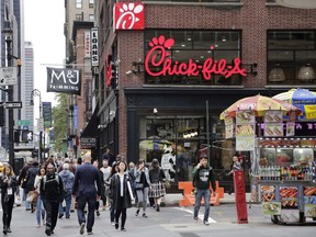 Chick-fil-A, the controversial American fast food company, said Wednesday that it will open its first Canadian restaurant in Toronto next year and has plans to bring about 15 of its locations to the Greater Toronto Area over the next five years. People walk past a new Chick-fil-A restaurant, Thursday, Oct. 1, 2015 in New York.