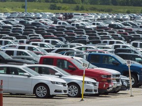 Vehicles are seen in a parking lot at the General Motors Oshawa Assembly Plant in Oshawa, Ont. For the first time since March 2013, there was a decline in Canadian year-to-date new light vehicles sales.