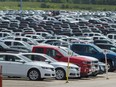 Vehicles are seen in a parking lot at the General Motors Oshawa Assembly Plant in Oshawa, Ont. For the first time since March 2013, there was a decline in Canadian year-to-date new light vehicles sales.